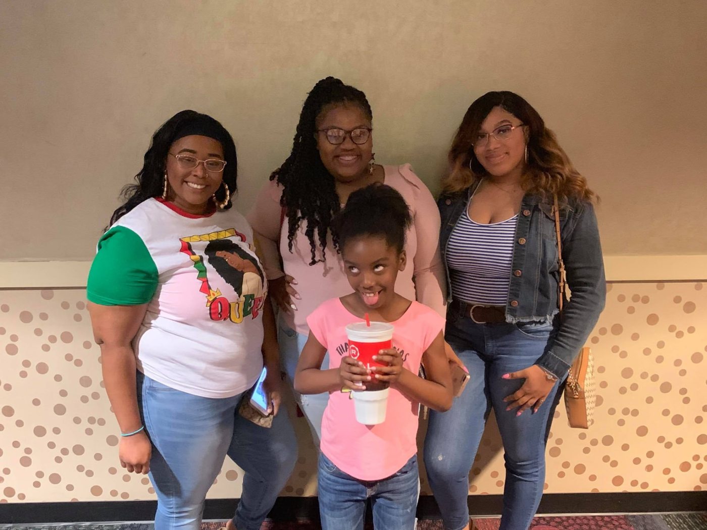 Guests posing together in the theater lobby in 2019
